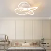 A modern bedroom with a stylish ceiling light fixture above a bed. Produktbild-Vorschau