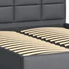 Close-up view of a bed frame with a slatted base and a dark gray upholstered headboard. Produktbild-Vorschau