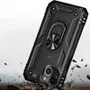 A black rugged phone case with a ring holder is shown falling onto a rocky surface, with debris flying. Produktbild-Vorschau