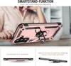 A person's hands are holding a rose gold phone case with a ring stand, displayed on a table. Produktbild-Vorschau