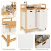 A bamboo laundry sorter with two compartments and shelves, featuring close-up details of its construction and materials. Anteprima dell’immagine prodotto