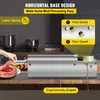 A stainless steel sausage stuffer is shown in a kitchen setting, with a hand adding meat to the machine and sausages already made. Náhled obrázku produktu