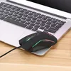 A black wired gaming mouse with LED lighting rests on the palm rest of a laptop. Produktbild-Vorschau