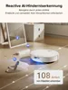 A white robot vacuum cleaner is shown on a wooden floor, navigating around slippers and a power strip. The image includes text overlays highlighting its features. Produktbild-Vorschau