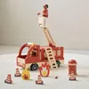 A wooden toy fire truck with accessories on a light-colored rug. Produktbild-Vorschau