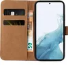 A brown leather wallet-style phone case is open, showing card slots and banknotes, with a smartphone inside. Produktbild-Vorschau