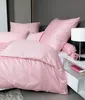 A neatly made bed with pink bedding, including a duvet and pillows, in a bedroom setting. Produktbild-Vorschau