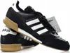 A pair of black Adidas Mundial Goal soccer shoes with white stripes and tan soles, presented on a white background. Náhled obrázku produktu