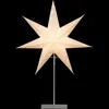 A lit, eight-pointed star-shaped lamp on a stand, against a black background. Produktbild-Vorschau
