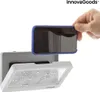 A hand is holding a smartphone with a blue case, about to place it into a white waterproof case mounted on a wall. The waterproof case has water droplets on its transparent cover. Podgląd zdjęcia produktu