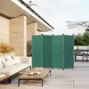 An outdoor patio with a sofa, coffee table, and a green folding screen divider. Produktbild-Vorschau