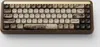 A top-down view of a mechanical keyboard with a wooden case and decorative keycaps. Produktbild-Vorschau