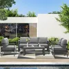 An outdoor patio setting with a modern grey sofa set and coffee table next to a swimming pool. Produktbild-Vorschau