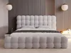 A modern bedroom with a large, upholstered bed as the focal point. Produktbild-Vorschau