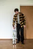 A man is standing in a room with a folded ladder. Produktbild-Vorschau