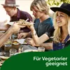 People enjoying a meal outdoors, sharing food from plates. Produktbild-Vorschau