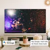 A modern living room setup with a TELEFUNKEN TV displaying a concert, a cactus, and a smartphone on a wooden stand. Produktbild-Vorschau