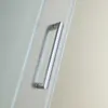 A close-up of a shower door handle on a frosted glass shower door. Produktbild-Vorschau
