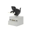 A black cat figurine on a gray base, holding a toothpick. Podgląd zdjęcia produktu