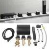 A black bathtub faucet set with a waterfall spout and multiple controls, along with its various plumbing components, laid out on a white surface. Produktbild-Vorschau