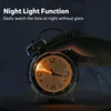 A hand is pressing the top of a retro alarm clock, illuminating its face. Voir les images du produit