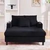 A black chaise lounge sofa with corduroy texture is shown in a well-lit room with shelves and a framed picture in the background. Náhled obrázku produktu