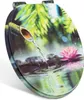 A toilet seat with a nature-themed design featuring a bamboo fountain, water, stones, and a lotus flower. Produktbild-Vorschau