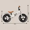 A white balance bike for children with brown accents and measurement indicators. Náhled obrázku produktu