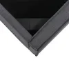 A close-up view of the corner of a grey upholstered bed frame, showing the fabric texture and stitching. Produktbild-Vorschau