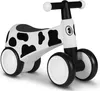A white and black cow-print balance bike is shown against a white background. Náhled obrázku produktu