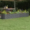 A raised garden bed filled with plants in a backyard setting. Podgląd zdjęcia produktu