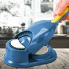 A hand is using a blue and yellow ravioli maker to create dumplings in a kitchen setting. Podgląd zdjęcia produktu