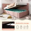 A pink upholstered bed with its storage compartment open, revealing stored items. The image also includes a close-up of the bed's hydraulic frame and icons illustrating storage possibilities. Produktbild-Vorschau