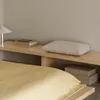 A bedroom scene with a bed, a shelf, and a pillow. Produktbild-Vorschau