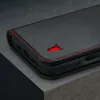 A close-up shot of a black leather iPhone case with red stitching and a red bull logo. Produktbild-Vorschau