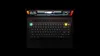 A top-down view of a black mechanical keyboard placed on a laptop. Produktbild-Vorschau
