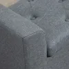 A close-up view of the armrest and tufted back of a gray upholstered bench. Podgląd zdjęcia produktu