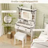 A white vanity table with a lighted mirror and stool, set up in a bedroom. Voir les images du produit