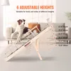 A dog is lying on a couch next to a wooden pet ramp that is adjusted to different heights. Anteprima dell’immagine prodotto