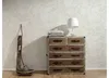 A chest of drawers with a lamp and pillows on top, next to a decorative wooden object. Podgląd zdjęcia produktu