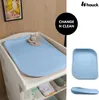 A light blue changing mat on a changing table, with a small stuffed animal on it. The image also shows a close-up of the mat and a side view of it. Anteprima dell’immagine prodotto
