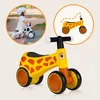 A collage showing a child riding a balance bike and a close-up of a giraffe-themed balance bike. Anteprima dell’immagine prodotto