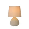 A table lamp with a fabric shade and a textured base. Náhled obrázku produktu