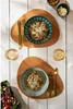 A top-down view of two place settings with pasta dishes, glasses of wine, and side dishes, set on a white wooden table. Voir les images du produit