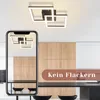 A modern kitchen with a black table and chairs, featuring a ceiling light fixture. Produktbild-Vorschau