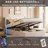 A bed with its storage compartment open, showcasing LED lighting and a remote control. Produktbild-Vorschau
