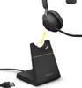A black Jabra headset charging stand with a USB cable connected, and a Jabra headset positioned above it, indicating it is for charging. Produktbild-Vorschau