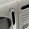 A close-up shot of a microwave oven's handle and control panel. Anteprima dell’immagine prodotto