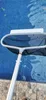 A pool skimmer is being used to clean a swimming pool. Produktbild-Vorschau