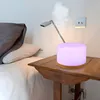 A bedside table with an aroma diffuser and a lamp. Anteprima dell’immagine prodotto